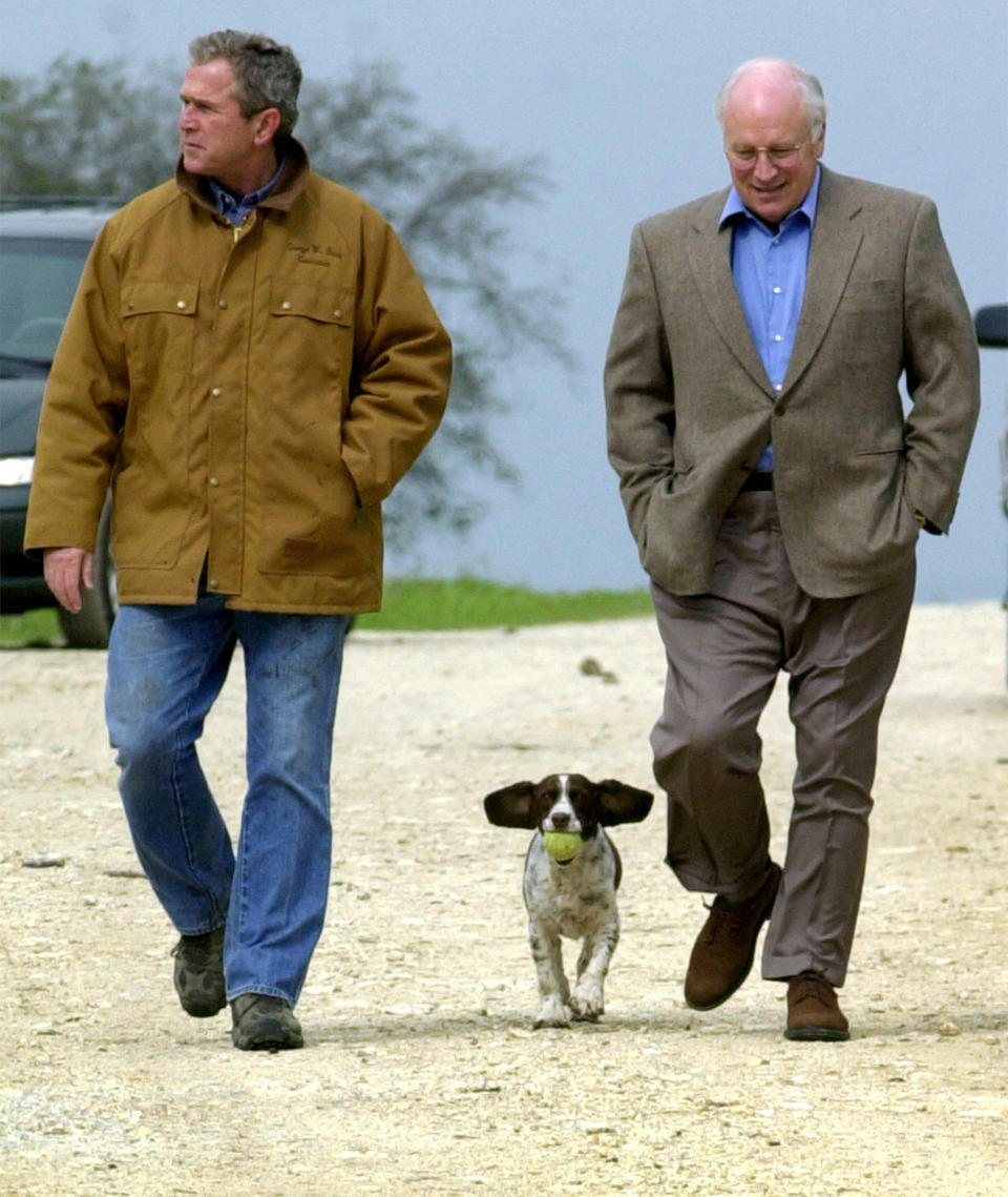 This Nov. 11, 2000 file photo shows then Republican presidential candidate Texas Gov. George W. Bush and running mate Dick Cheney walk down a dirt road to meet with reporters, followed by Bush's dog Spot, near Crawford, Texas.  (AP Photo/Eric Draper, file)