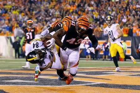 Dec 4, 2017; Cincinnati, OH, USA; Pittsburgh Steelers wide receiver Antonio Brown (84) catches the game tying touchdown against Cincinnati Bengals cornerback Dre Kirkpatrick (27) and is hit as a penalty of unnecessary roughness is called on free safety George Iloka (right) in the second half at Paul Brown Stadium. Mandatory Credit: Aaron Doster-USA TODAY Sports