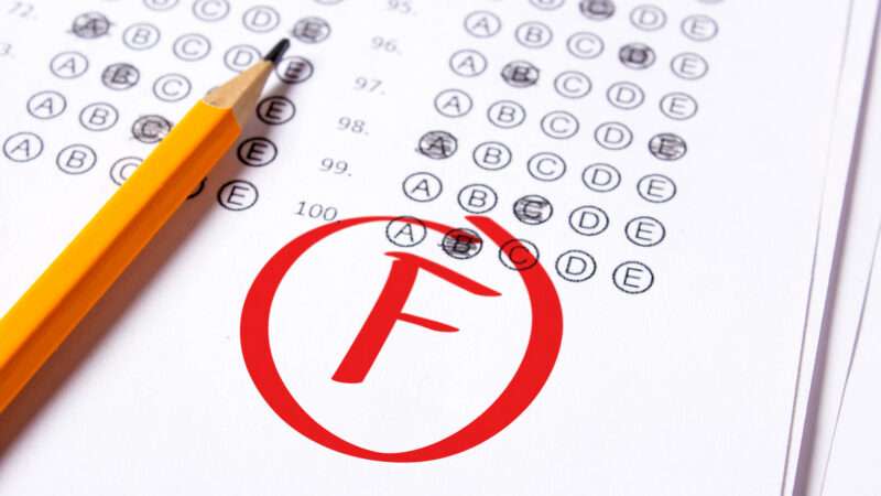 A test paper with questions filled out, a pencil sitting on the page, and a big red 'F' with a circle around it