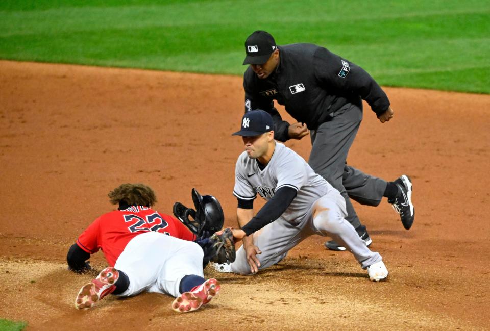 Oct 15, 2022; Cleveland, Ohio, USA; Cleveland Guardians first baseman Josh Naylor (22) slides ahead of the tag from New York Yankees shortstop Isiah Kiner-Falefa (12) in the second inning during game three of the NLDS for the 2022 MLB Playoffs at Progressive Field. Mandatory Credit: David Richard-USA TODAY Sports