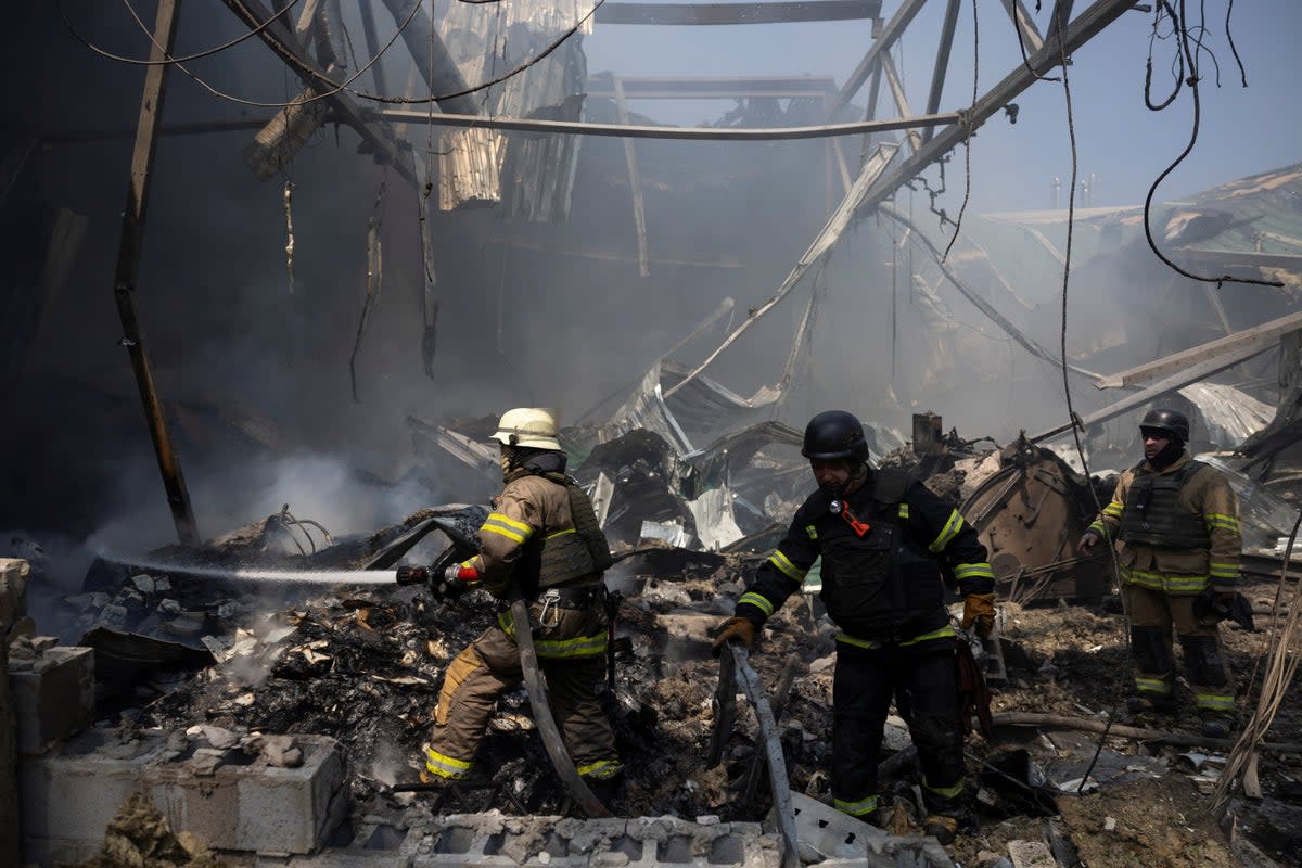 Firefighters work at the site where a printworks was hit by Russian missile strikes (Reuters)