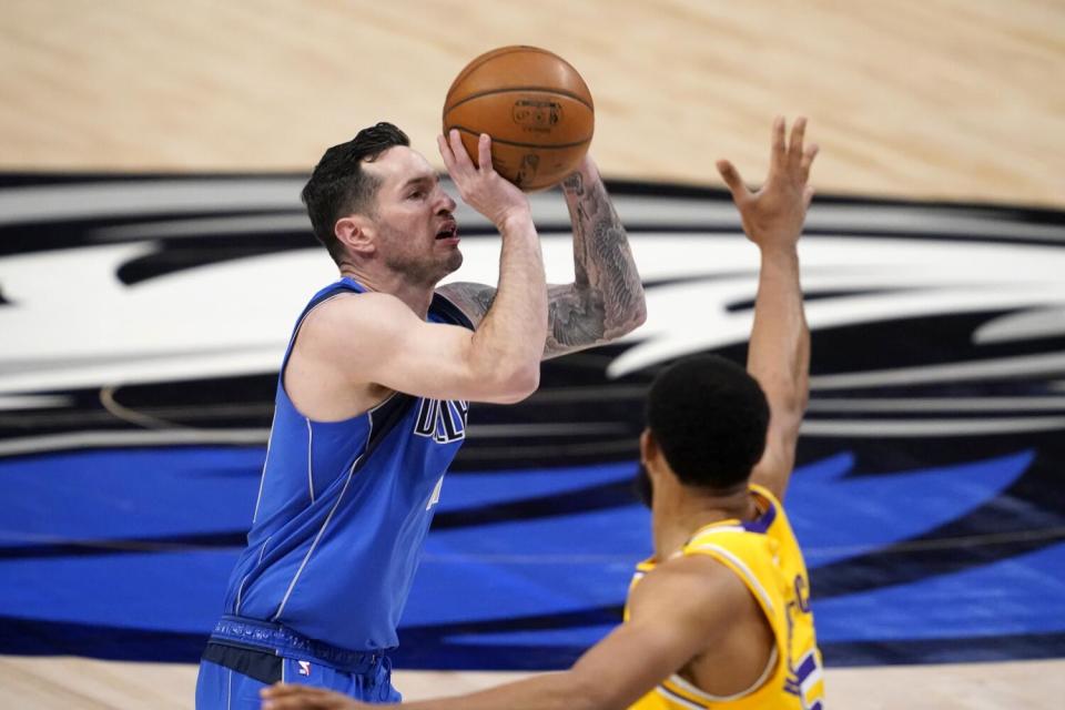 JJ Redick takes a shot over Lakers guard Talen Horton-Tucker during a game when he played with the Mavericks in 2021.