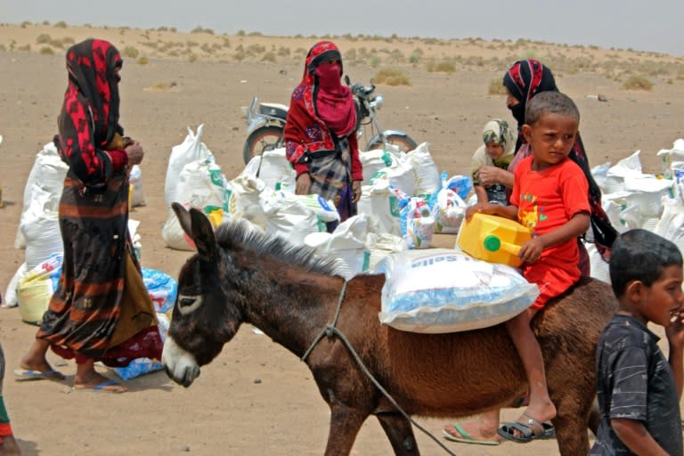 Poor Yemeni families receive basic food supplies in Lahj; years of conflict have pushed millions to the brink of famine (AFP/Saleh Al-OBEIDI)