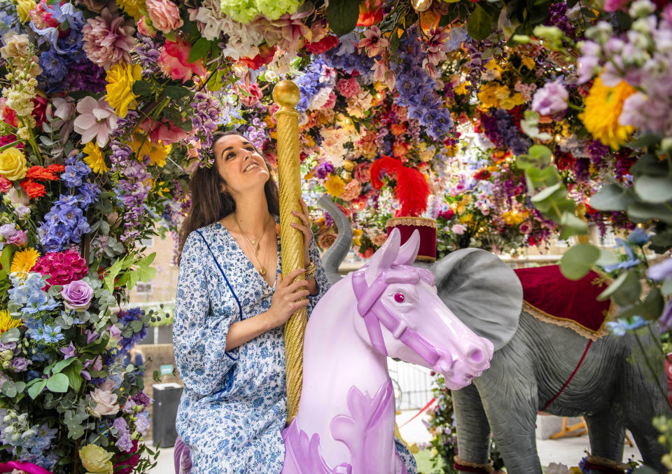 <p>Competition judge, Rosanna Falconer looks at a floral carousel installation in Halkin Arcade, which has been designed by florists Neill Strain and Judith Blacklock for the Belgravia in Bloom festival, running from September 20-26, London. Picture date: Monday September 2021.</p>
