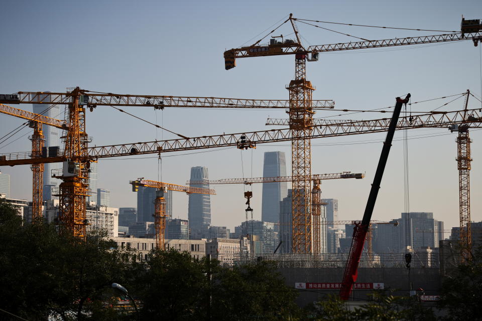 A view shows cranes in front of the skyline of the Central Business District (CBD) in Beijing, China, October 18, 2021.   REUTERS/Thomas Peter