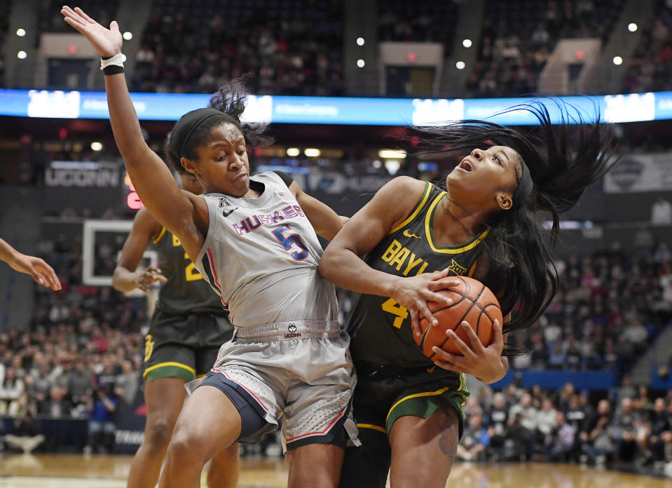 Connecticut's Crystal Dangerfield, left, fouls Baylor's Te'a Cooper during the first half of an NCAA college basketball game Thursday, Jan. 9, 2020, in Hartford, Conn. (AP Photo/Jessica Hill)