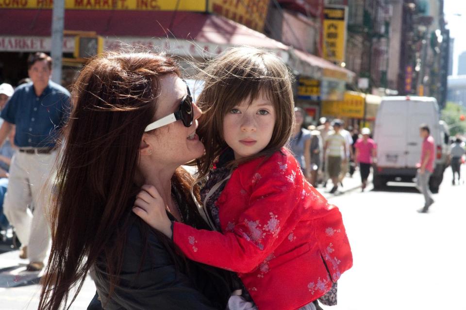 This film image released by Millennium Entertainment shows Julianne Moore, left, and Onata Aprile in a scene from "What Maisie Knew." (AP Photo/Millennium Entertainment, JoJo Whilden)