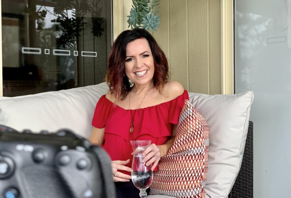 Headshot of Nicole Pedersen-McKinnon with a glass of water to represent International Women's Day