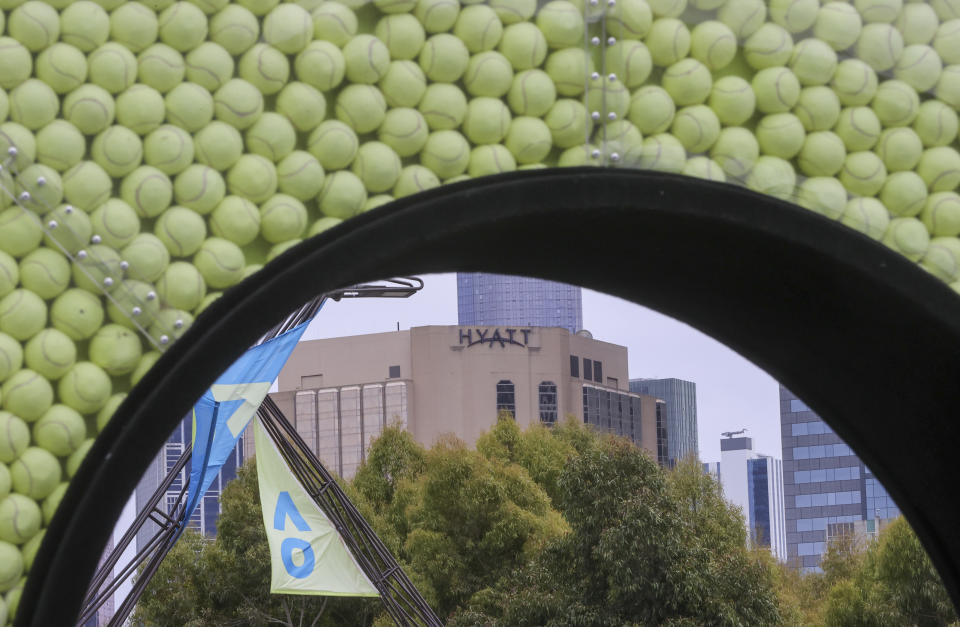 The Grand Hyatt hotel seen from Melbourne Park, venue for the Australian Open tennis championships in Melbourne, Australia, Thursday, Feb. 4, 2021. All competition at six Australian Open tuneup events scheduled for Thursday was called off after a worker at one of the tournaments' Melbourne quarantine hotels tested positive for COVID-19.(AP Photo/Hamish Blair)