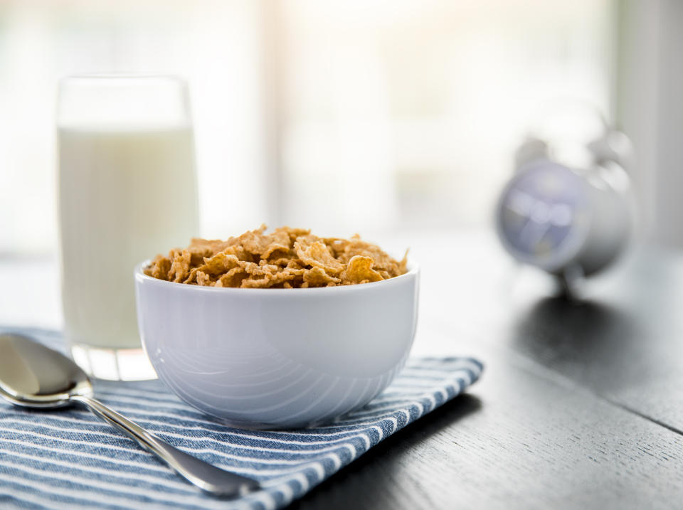 Bowl of cereal and glass of milk on a table