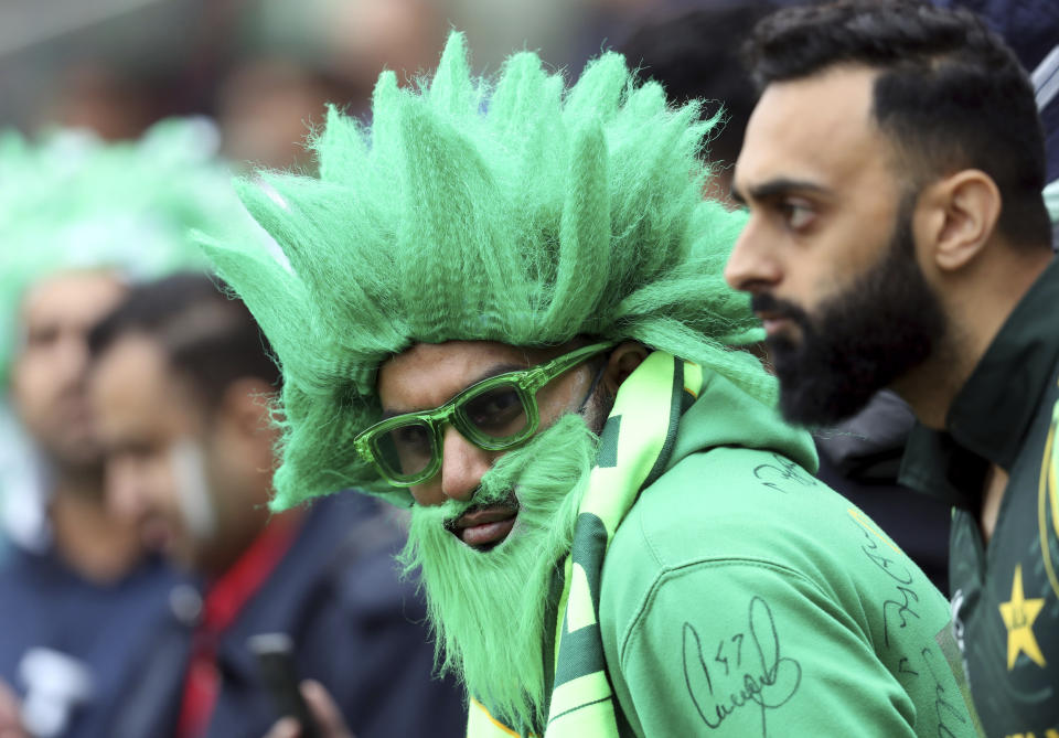 A Pakistan fan wait as rain is expected to slightly delay the start of play during the Cricket World Cup match between New Zealand and Pakistan at the Edgbaston Stadium in Birmingham, Wednesday, June 26, 2019. (AP Photo/Rui Vieira)