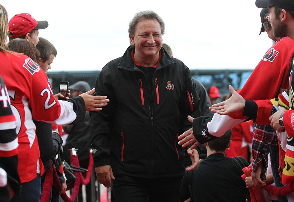 OTTAWA, ON – OCTOBER 17: Ottawa Senators owner Eugene Melnyk high-fives fans as he walks down the red carpet before the home opener against the New Jersey Devils at Canadian Tire Centre on October 17, 2013 in Ottawa, Ontario, Canada. (Photo by Andre Ringuette/NHLI via Getty Images)