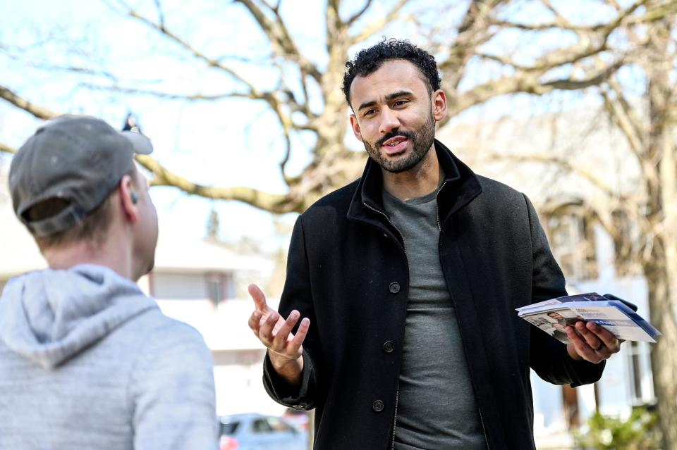 At right, Jon Horford, a democratic candidate for Michigan's new 77th State House district, talks with Cody Bernard while Horford campaigns on Tuesday, March 29, 2022, in Lansing.