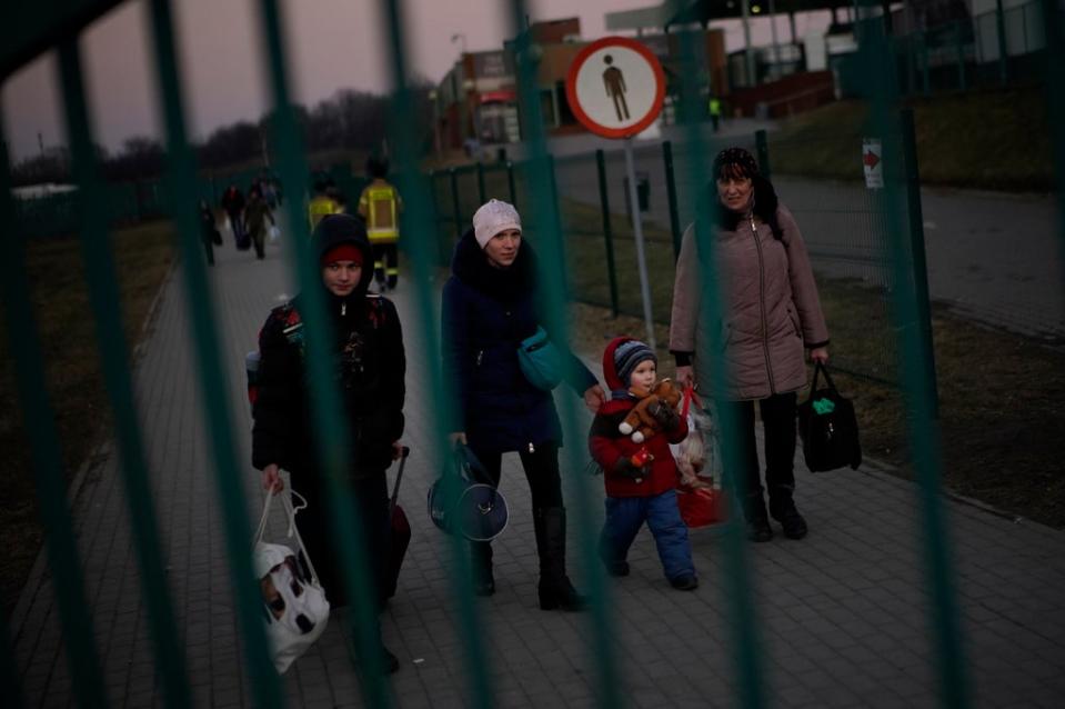 A group of people, who have fled Ukraine, arrive at the border crossing in Medyka, Poland (Daniel Cole/AP) (AP)