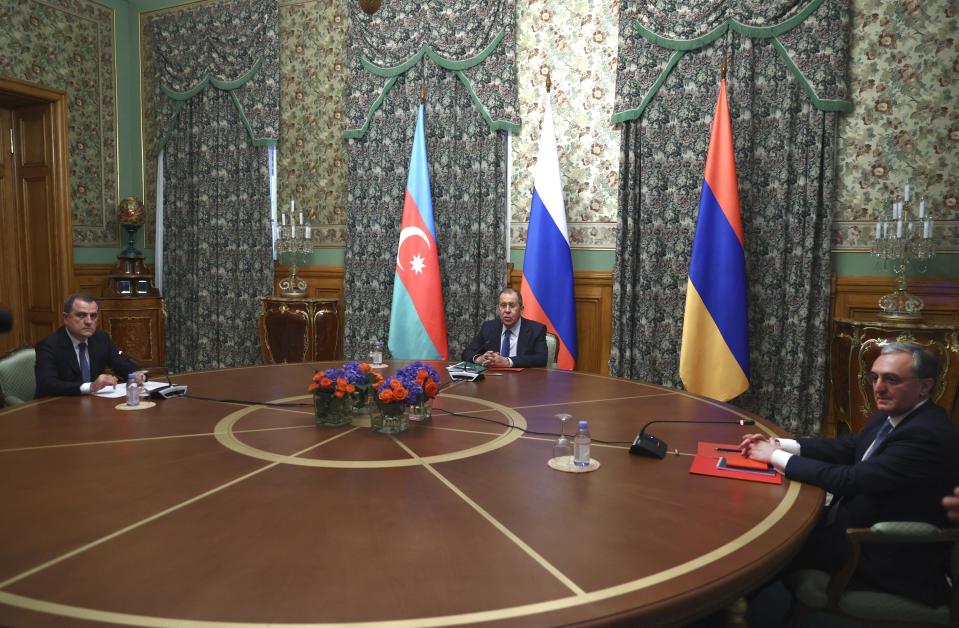 In this photo released by Russian Foreign Ministry Press Service, Russian Foreign Minister Sergei Lavrov, centre, Armenia's Foreign Minister Zohrab Mnatsakanyan, right, and Azerbaijan's Foreign Minister Jeyhun Bayramov seen during their meeting in Moscow, Russia, Friday, Oct. 9, 2020. Russia is moving to stop the worst escalation of fighting in the separatist region of Nagorno-Karabakh in more than a quarter-century by hosting cease-fire talks on Friday. Russian President Vladimir Putin issued a statement calling for a break in the fighting between the Armenian and Azerbaijani forces that have raged for nearly two weeks. (Russian Foreign Ministry Press Service via AP)