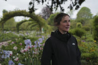 English gardener Claire-Helene Marron looks on in the garden of Claude Monet's house, French impressionist painter who lived from 1883 to 1926, ahead of the re-opening, in Giverny, west of Paris, Monday May 17, 2021. Lucky visitors who'll be allowed back into Claude Monet's house and gardens for the first time in over six months from Wednesday will be treated to a riot of color, with tulips, peonies, forget-me-nots and an array of other flowers all competing for attention. (AP Photo/Francois Mori)