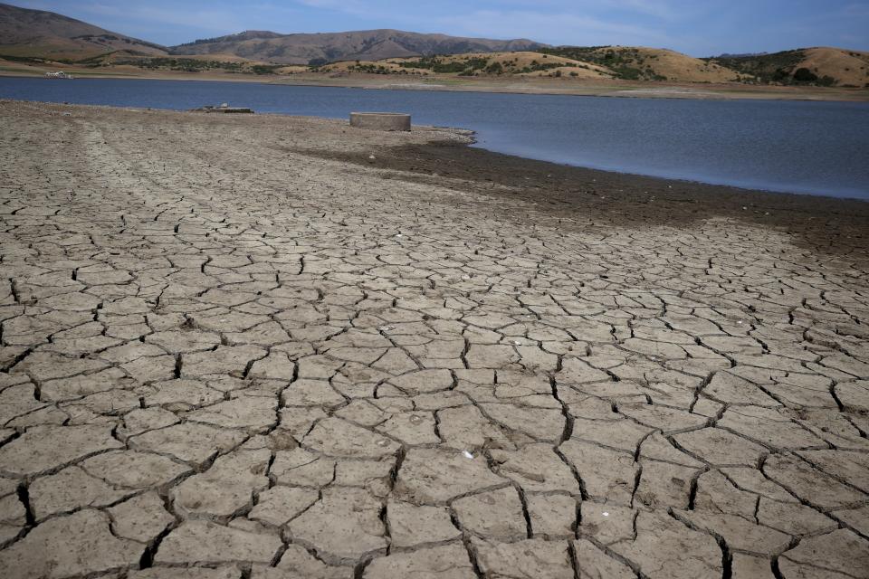 File: This cracked, dry reservoir bed in Northern California looks like most around the state in the third year of drought.