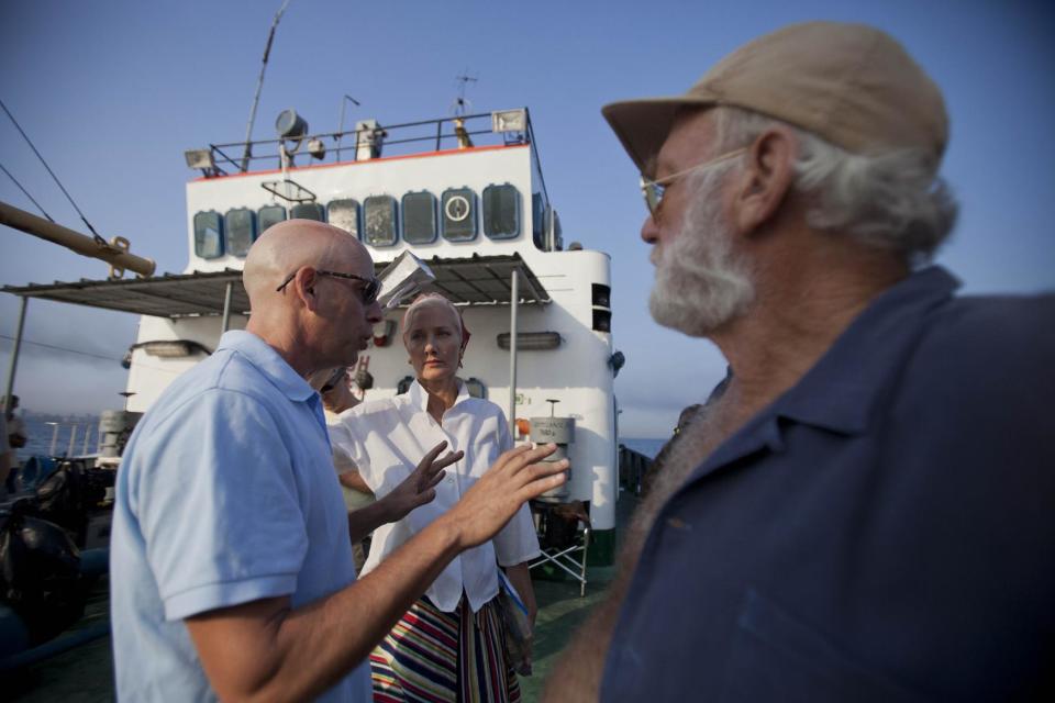 In this April 24, 2014 photo, film director Bob Yari, left, works with actors Joely Richardson, center, and Adrian Sparks, right, during the filming of the movie "Papa" in Havana bay, Cuba. Though the title derives from the Nobel Prize-winning novelist's nickname, the movie is based on an autobiographical script by Denne Bart Petitclerc, who is played by Giovanni Ribisi, while Hemingway is portrayed by theater and screen veteran Adrian Sparks. (AP Photo/Yesica Fish)