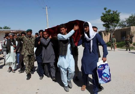 Relatives carry the coffin of one of the victims a day after an attack on an army headquarters in Mazar-i-Sharif, northern Afghanistan April 22, 2017. REUTERS/Anil Usyan