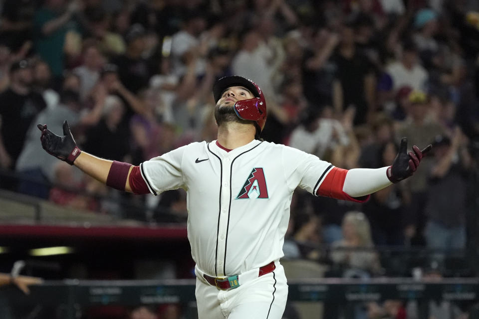 Arizona Diamondbacks' Eugenio Suarez celebrates his three-run home run against the St. Louis Cardinals during the fifth inning of a baseball game Friday, April 12, 2024, in Phoenix. (AP Photo/Ross D. Franklin)