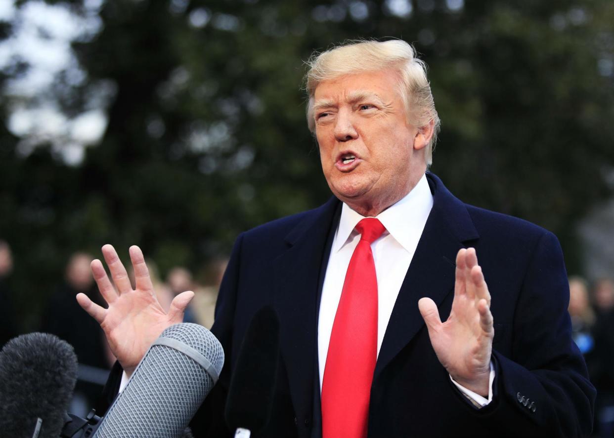 President Donald Trump speaks to reporters before leaving the White House in Washington, Friday, Dec. 15, 2017, for a trip to Quantico, Virginia to attend the FBI National Academy graduation ceremony. (AP Photo/Manuel Balce Ceneta)