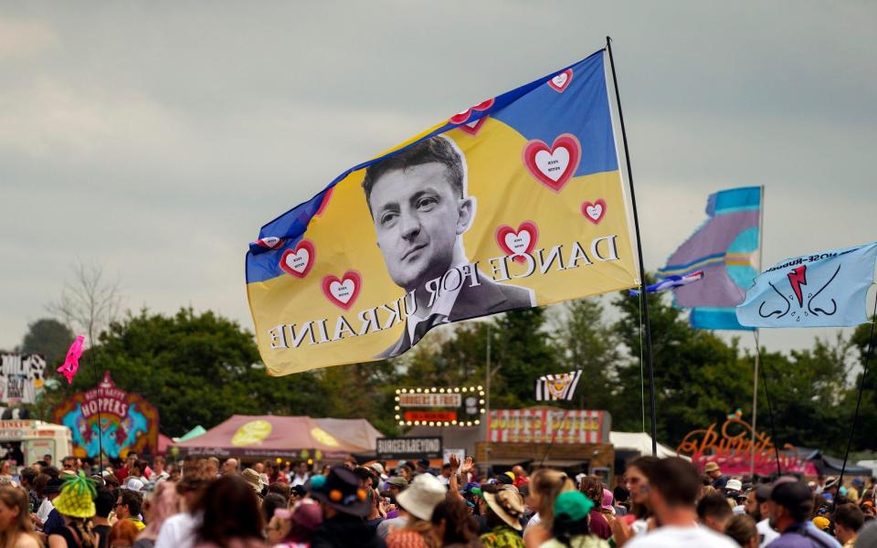 A flag with the image of Ukrainian President Volodymyr Zelenskyy and the words 'Dance For Ukraine' is seen at the Glastonbury Festival in Worthy Farm, Somerset, England, Friday, June 24 - Scott Garfitt/AP