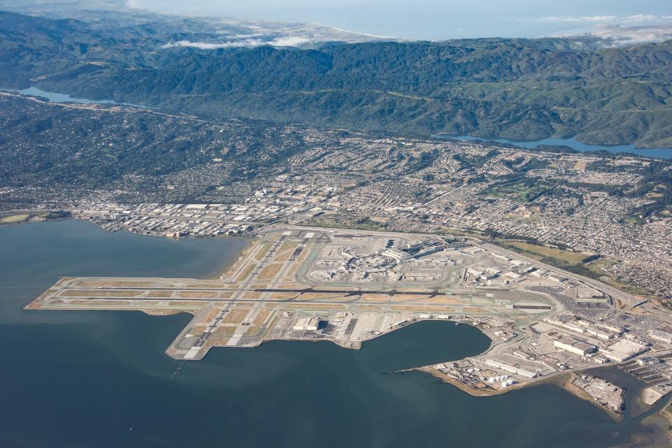 An aerial view shows San Francisco International Airport, which is located on the water and sits less than 16 feet above sea level.