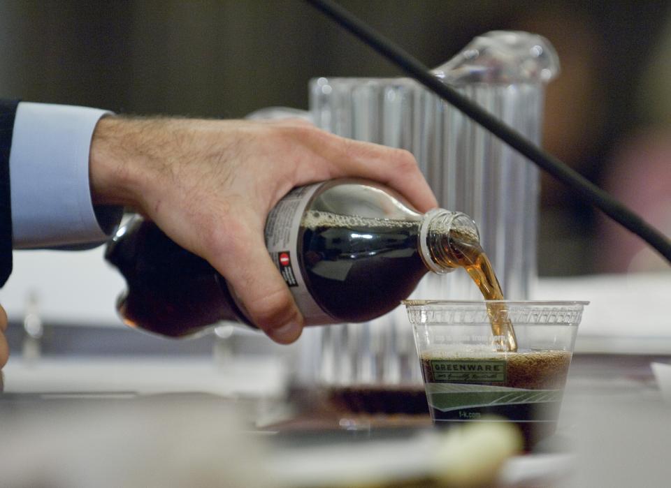 Then-White House Budget Director Peter R. Orszag pours himself some Diet Coke during a House Budget hearing. (Photo by Scott J. Ferrell/Congressional Quarterly/Getty Images)