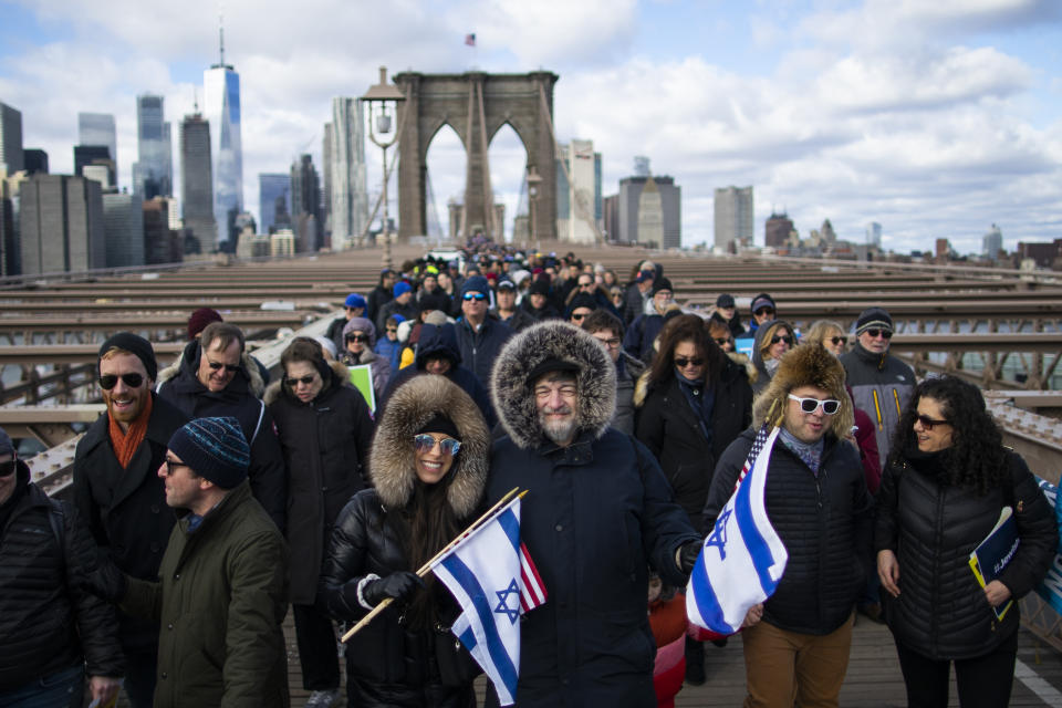 People take part in a march crossing the Brooklyn Bridge in solidarity with the Jewish community after recent string of anti-semitic attacks throughout the greater New York area, on Sunday, Jan. 5, 2020 in New York. (AP Photo/Eduardo Munoz Alvarez)