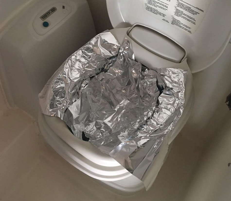 A camper van toilet covered in foil.