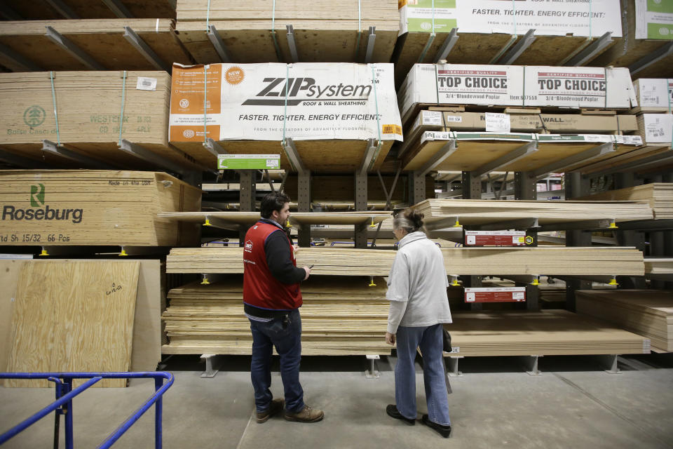 FILE - In this Feb. 23, 2018, file photo Lowe's Assistant Store Manager Patrick Mulloney, of Marlborough, Mass., left, assists customer Karen Frank, of Framingham, Mass., right, at a Lowe's retail home improvement and appliance store, in Framingham. Lowe's Companies, Inc. reports financial results Wednesday, Aug. 21, 2019. (AP Photo/Steven Senne, File)