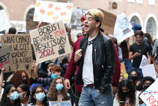 People take part in a protest outside the Department for Education in London in response to the downgrading of A-level results