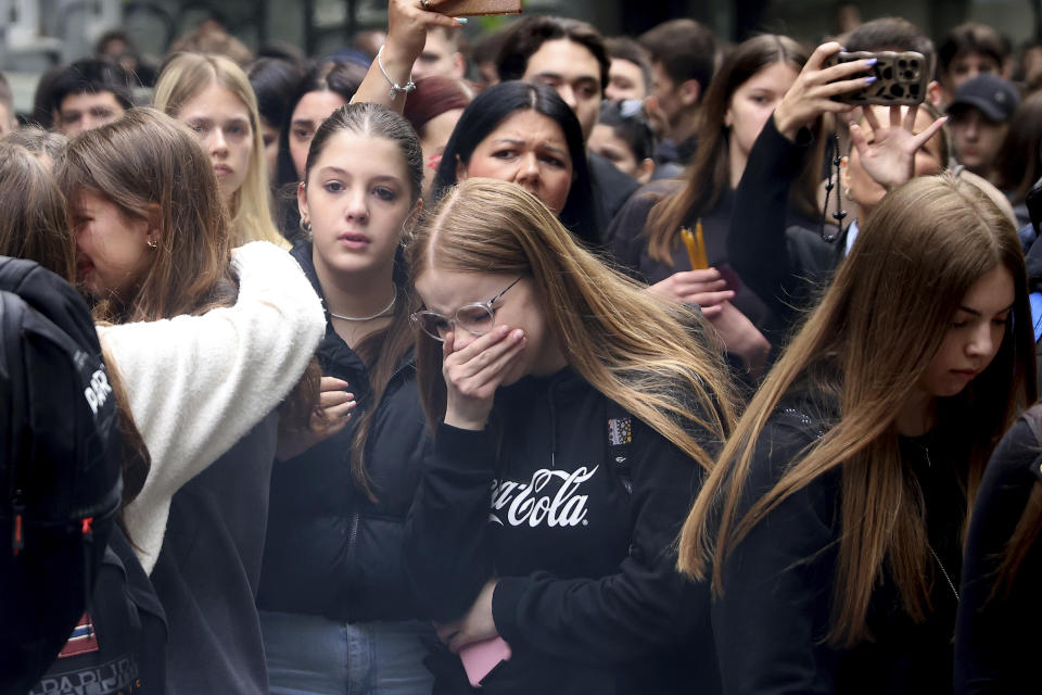 School children mourn the victims near the Vladislav Ribnikar school in Belgrade, Serbia, Thursday, May 4, 2023. Many wearing black and carrying flowers, scores of Serbian students on Thursday paid silent homage to their peers killed a day earlier when a 13-year-old boy used his father’s guns in a school shooting rampage that sent shock waves through the nation and triggered moves to boost gun control. (AP Photo/Armin Durgut)