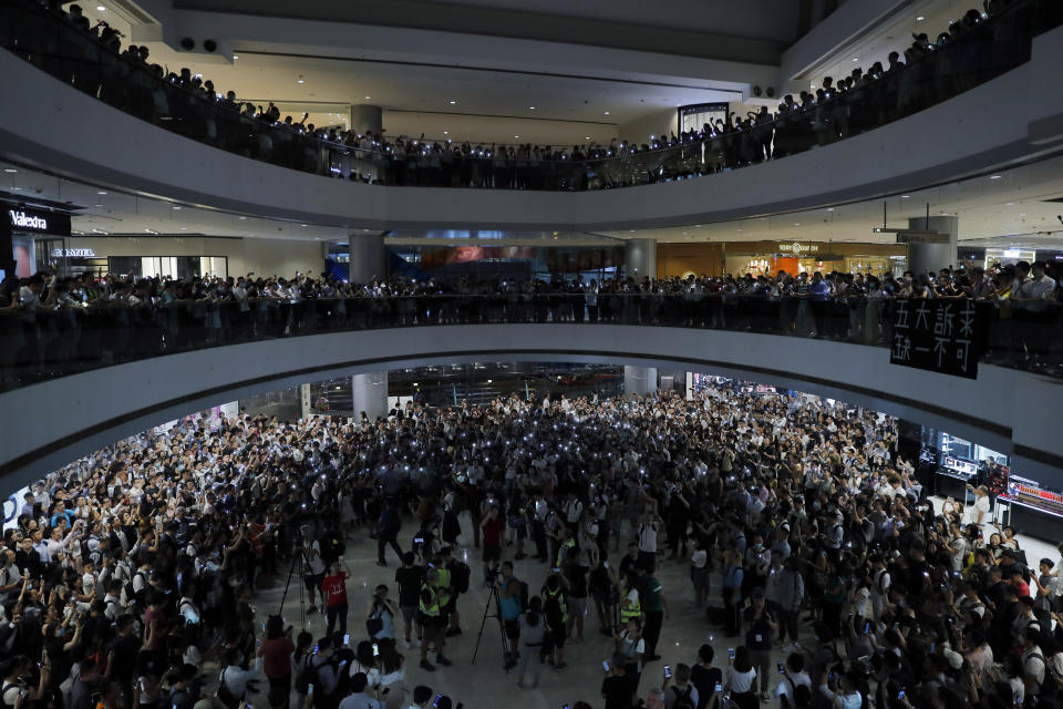 Demonstrators sing a theme song written by protestors "Glory to Hong Kong" at the International Finance Centre (ifc) shopping mall in Hong Kong, Thursday, Sept. 12, 2019. Thousands of people belted out a new protest song at Hong Kong's shopping malls in an act of resistance that highlighted the creativity of demonstrators in their months-long fight for democratic freedoms in the semi-autonomous Chinese territory. (AP Photo/Kin Cheung)