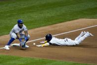 Milwaukee Brewers' Orlando Arcia slides safely into third with Kansas City Royals third baseman Maikel Franco covering during the eighth inning of a baseball game Saturday, Sept. 19, 2020, in Milwaukee. Arcia advanced from first on a wild pick off throw. (AP Photo/Morry Gash)