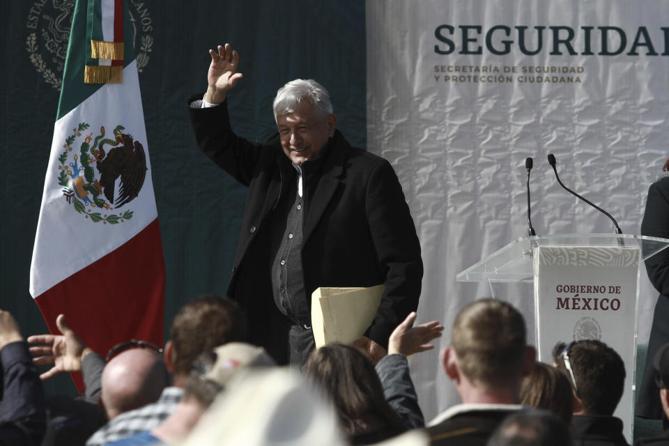 Mexico's President Andres Manuel Lopez Obrador waves to residents during his visit to the small town of La Mora, Sonora state, Mexico, Sunday Jan. 12, 2020. Lopez Obrador said Sunday there is an agreement to establish a monument will be put up to memorialize nine U.S.-Mexican dual citizens ambushed and slain last year by drug gang assassins along a remote road near New Mexico. (AP Photo/Christian Chavez)