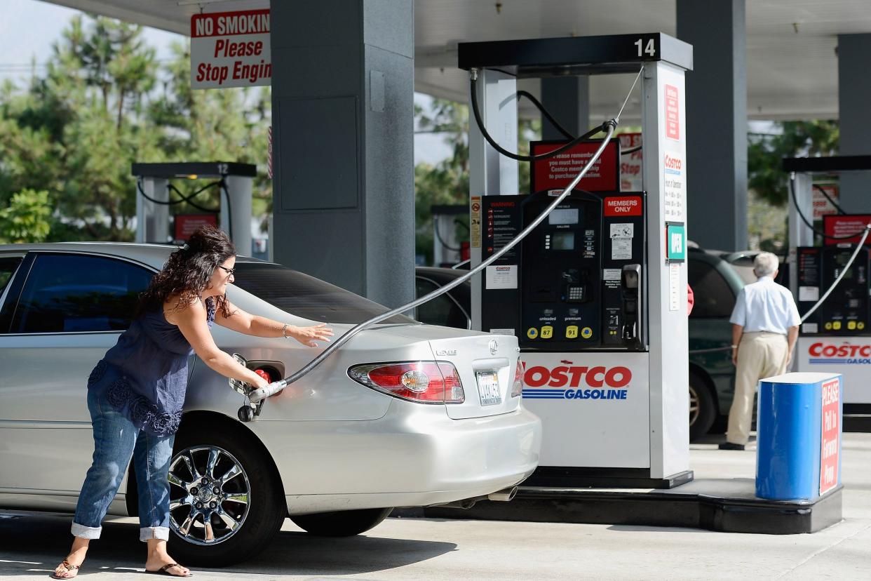 Customers gas up their car at Costco Wholesale Corp.