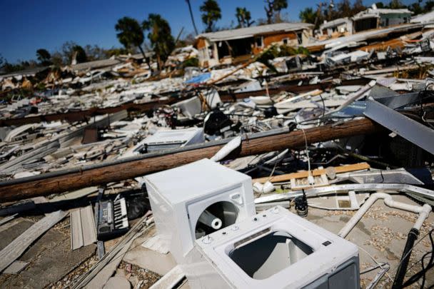 PHOTO: Household belongings and debris lie scattered in a trailer park, two days after the passage of Hurricane Ian, in Fort Myers Beach, Fla., Sept. 30, 2022. (Rebecca Blackwell/AP)
