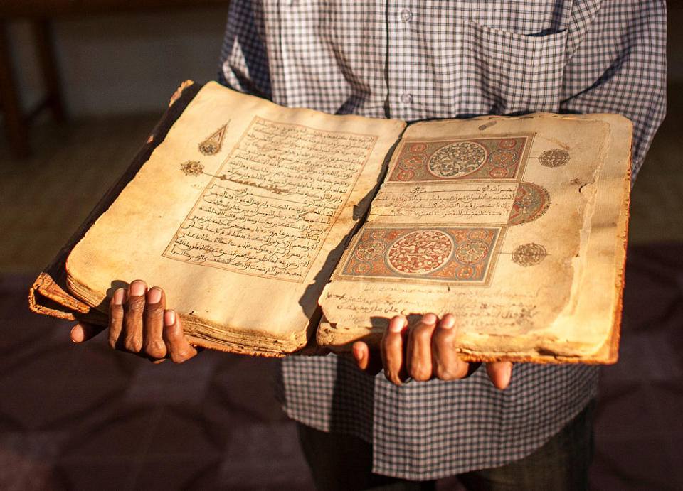 A librarian in Juma Al Majid Centre for the manuscripts conservation and restoration of Timbuktu shows one of the old manuscripts on January 19, 2010 in Timbuktu, Mali. | Andrea Borgarello—Getty Images