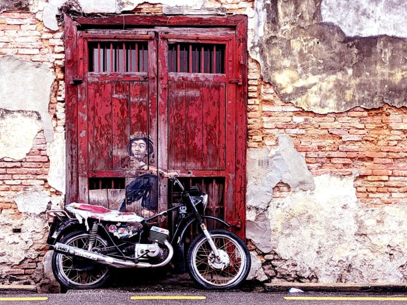 "Boy on Motorbike" by Ernest Zacharevics, in Ah Quee Street, is one of the most noted works of street art in Penang. The motorbike was left there behind by a tourist who rode it all the way from Vietnam to Penang, and it remains there years later Genevieve Tan Shu Thung/dpa