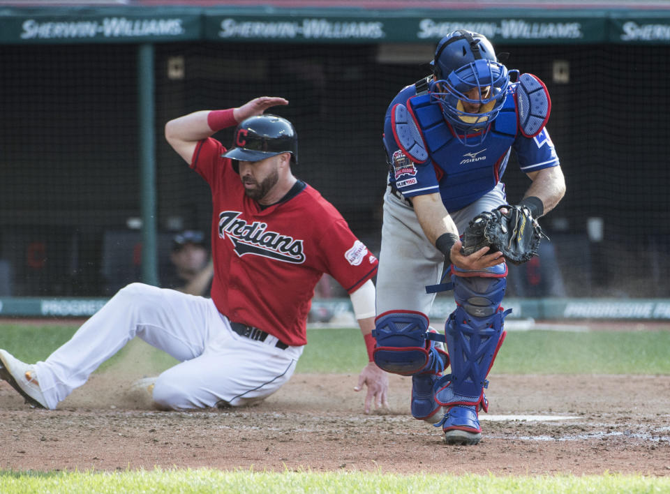 Cleveland Indians' Jason Kipnis scores as Texas Rangers' Jeff Mathis takes the throw from Nomar Mazara during the seventh inning of the second game of a baseball doubleheader in Cleveland, Wednesday, Aug. 7, 2019. (AP Photo/Phil Long)