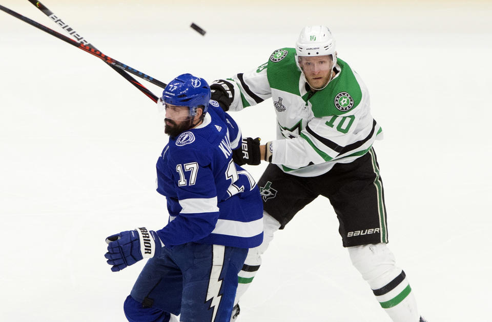 Dallas Stars' Corey Perry (10) and Tampa Bay Lightning's Alex Killorn (17) battle for the puck during first-period NHL Stanley Cup finals hockey action in Edmonton, Alberta, Monday, Sept. 21, 2020. (Jason Franson/The Canadian Press via AP)