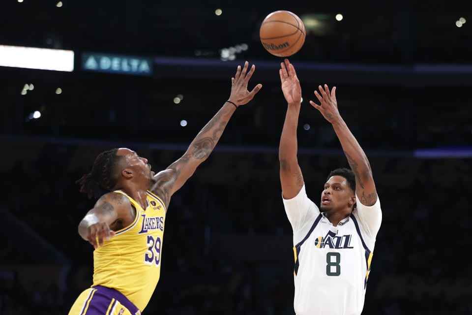 Utah Jazz forward Rudy Gay (8) shoots against Los Angeles Lakers center Dwight Howard (39) during the first half of an NBA basketball game in Los Angeles, Monday, Jan. 17, 2022. (AP Photo/Ringo H.W. Chiu)