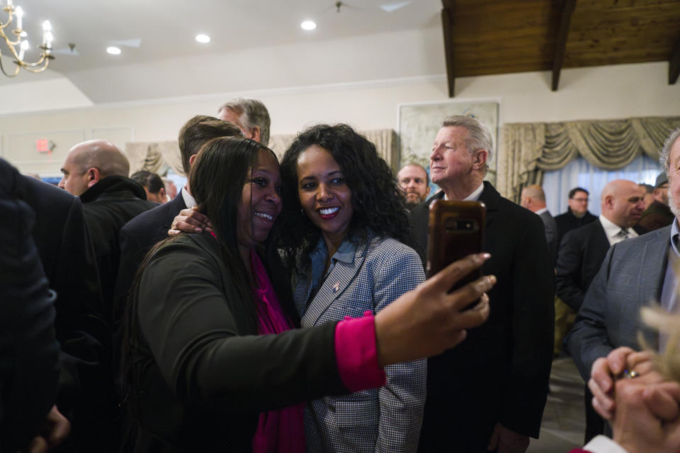 Congressional candidate Mazi Pilip, center right, poses for a photo and greets attendees at her fundraiser hosted by the Nassau County Republican Committee, Monday, Feb. 5, 2024, in Jericho, N.Y. The Tuesday contest for New York’s District 3 House seat held by George Santos until his recent expulsion is shaping up to be a bellwether in the fight for control of Congress, with Pilip pitted against GOP candidate former U.S. Rep Tom Suozzi. (AP Photo/Brittainy Newman)