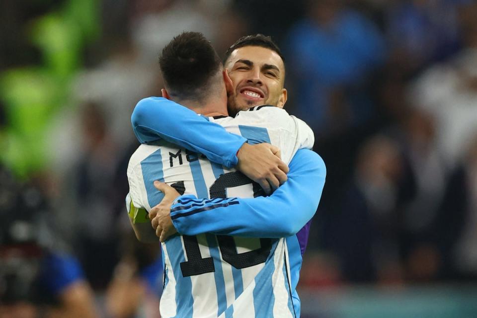 Leandro Paredes hugging Messi at the final whistle on Tuesday night. (REUTERS)