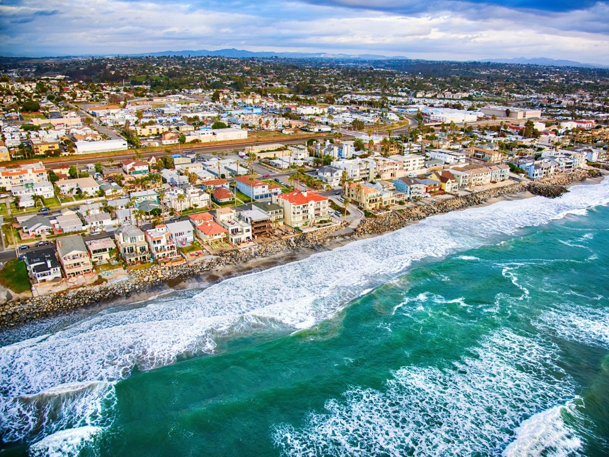 Oceanfront homes lining the coast of Oceanside, California located in northern San Diego County shot from an altitude of about 700 feet over the Pacific Ocean during a helicopter photo flight.