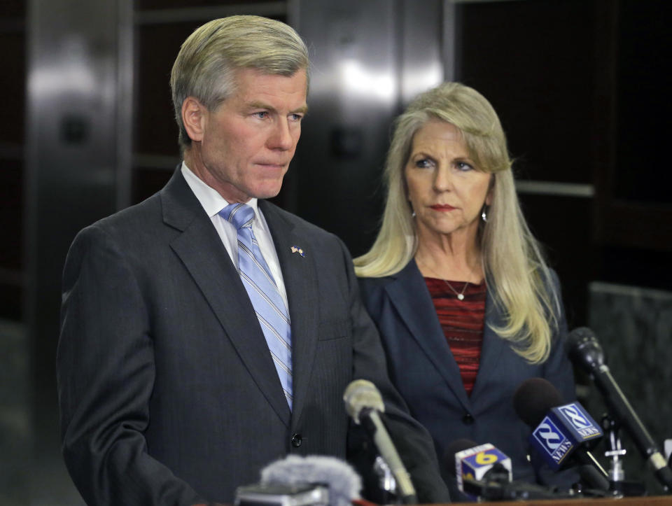 Former Virginia Gov. Bob McDonnell makes a statement as his wife, Maureen, listens during a news conference in Richmond, Va., Tuesday, Jan. 21, 2014. McDonnell and his wife were indicted Tuesday on corruption charges after a monthslong federal investigation into gifts the Republican received from a political donor. (AP Photo/Steve Helber)