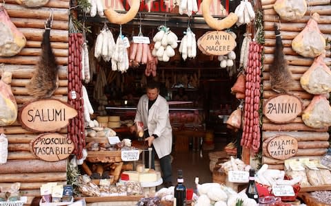 A butcher at work in his shop in Norcia