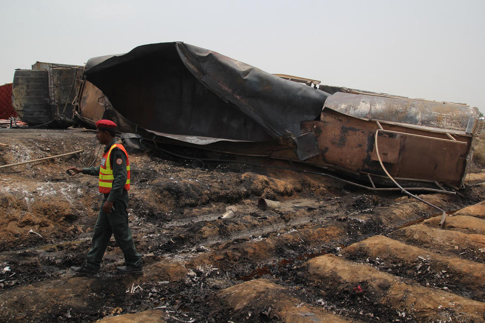 <p>Pakistani rescue workers gather beside an oil tanker which caught fire following an accident on a highway near the town of Ahmedpur East, some 670 kilometres (416 miles) from Islamabad on June 25, 2017. (Ss Mirza/AFP/Getty Images) </p>