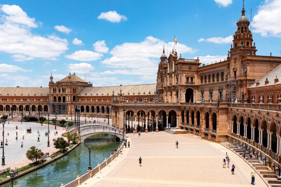 Plaza in Seville, Spain during the day with people walking around